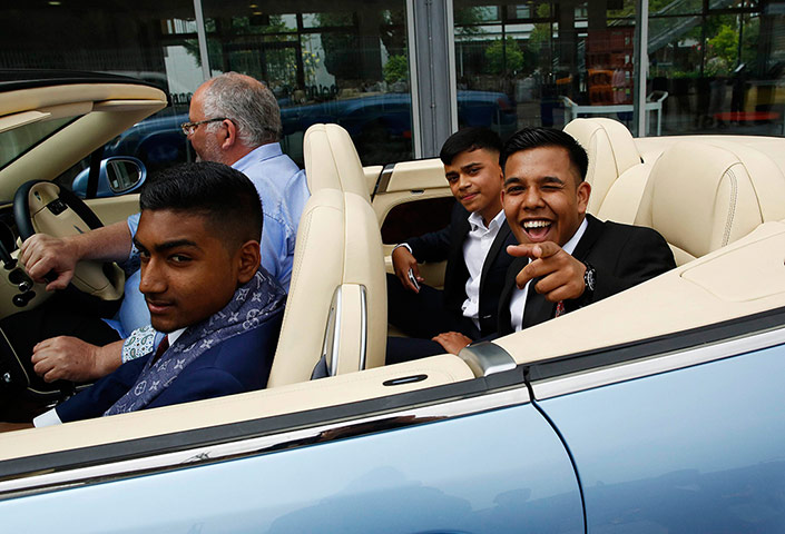 Supercar parade: Rezaul Alom, 16, points at the camera as he drives past with Mahir Magnet C