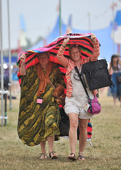 Womad weekend: Festival goers run to shelter from the rain