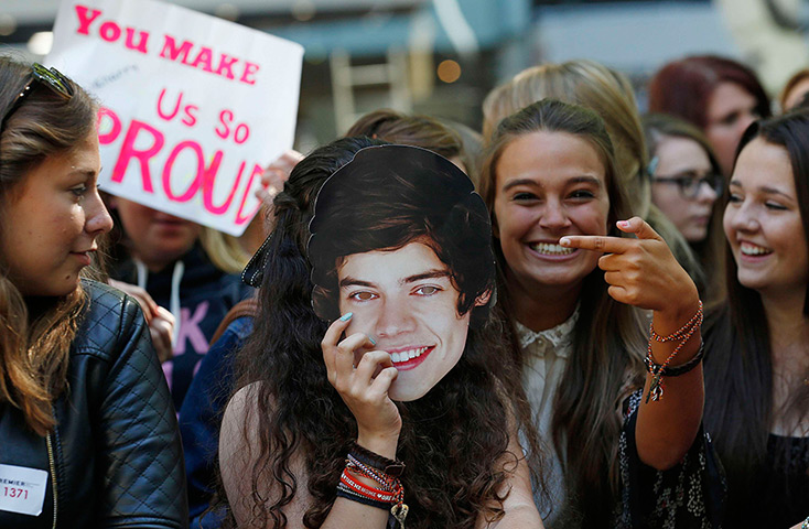 One Direction fans: A fan holds a mask depicting Harry Styles