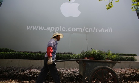 A worker walks in front of an Apple retail shop under construction in Shanghai, China.