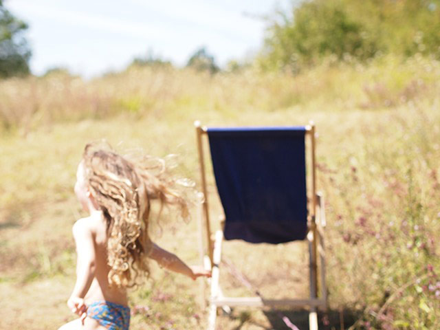 GreatSummerHolidayPhotos: Girl running next to deckchair