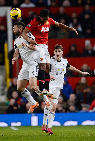 United v Swansea: Valencia outjumps Angel Rangel