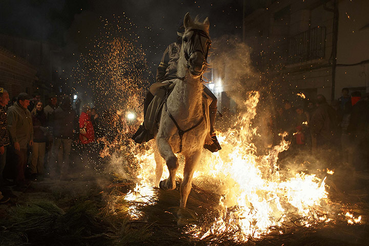 20 Photos: A man rides his horse the Luminarias annual religious celebration in Spain
