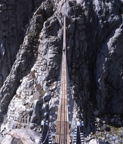 The Trift Bridge in the Swiss Alps stretches 170m over a glacial valley, with an icy 100m drop below. The suspension bridge - which took just six weeks to build - can be reached via a cable car which takes you across the gorge, and links up steep mountain trails, some of which are only suitable for the most experienced of mountain hikers.  http://www.grimselwelt.ch/grimsel-experience/activities/trift-bridge-hike/.