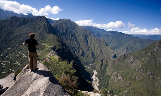 Man standing on top of Wayna Picchu looking down to Machu Picchu, Peru'