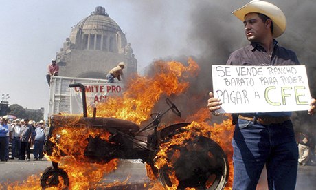 Mexican tractor drivers burn a tyre of one of their vehicles in Mexico City on 31 January 2008 prior to a rally against the North American Free Trade Agreement (NAFTA)., From ImagesAttr