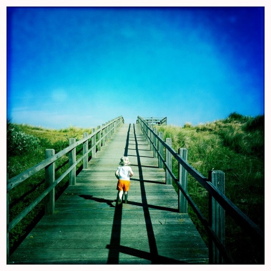 My three year old daughter walking to the beach