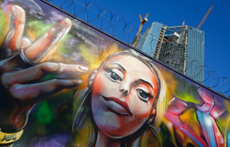 Graffiti is seen on a fence surrounding the construction site for the new headquarters of the European Central Bank (ECB) in Frankfurt August 28, 2013.