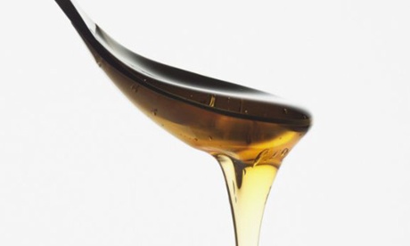 Honey dripping from a spoon