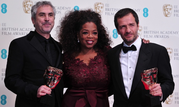 Out of this world … Mexican director Alfonso Cuarón (left) and British producer David Heyman (R) with Oprah Winfrey and their awards for an outstanding British film for Gravity.