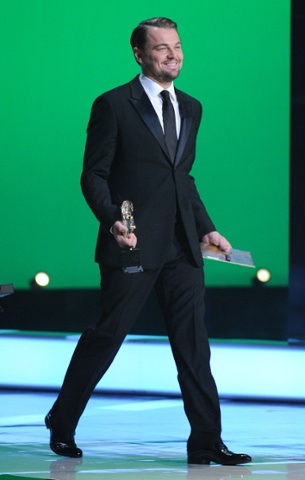 Leonardo Di Caprio heads on stage to present an award.