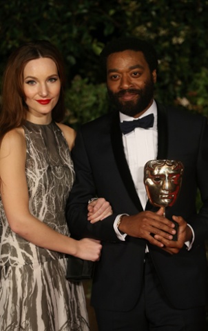 Chiwetel Ejiofor and Sari Mercer attend an official dinner party.