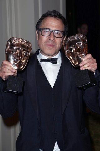 David O Russell with his Baftas for original screenplay and supporting actress (holding for a friend).