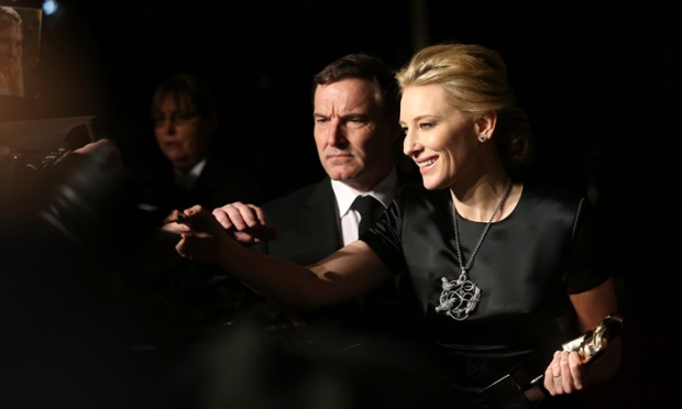 Cate Blanchett signs autographs as she arrives at the party. The ghost of Liz Taylor can just be made out in the background.