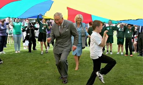 The Prince of Wales and Camilla, Duchess of Cornwall, take part in a 'parachute game' in Guernsey