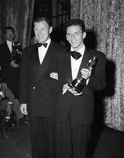 LIFE at the Oscars: Screen Actor's Guild President George Murphy with Frank Sinatra, who won a 