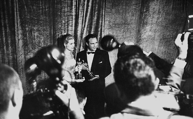 LIFE at the Oscars: Photographers surrounding Grace Kelly and Marlon Brando