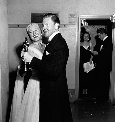 LIFE at the Oscars: Ginger Rogers dances with George Murphy backstage at the 1950 Academy Award