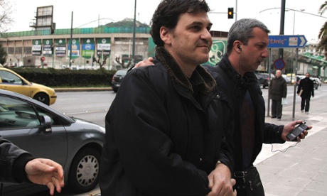 The former head of Greece s Hellenic Postbank, Angelos Filippidis, left, is led to police headquarters in Athens after his arrest on charges of providing unsecured loans to businessmen during his tenure, on Wednesday, Feb. 5, 2014.
