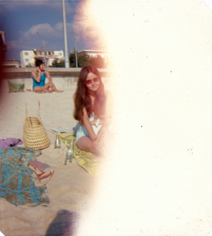 A disintegrated slide shows the reader's mother at the beach in Spain