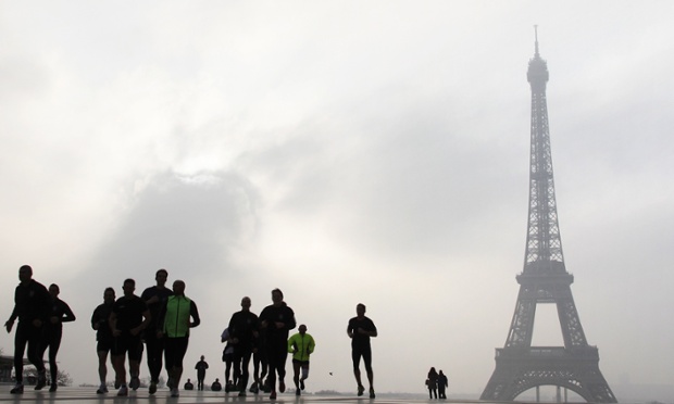 People jog on the Esplanade du Trocadero in front of the Eiffel tower 4 in Paris.