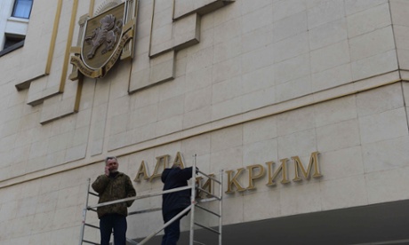 Workers dismantle the Ukrainian signs on Crimean Parliament building on March 18, 2014 in Simferopol, Ukraine.