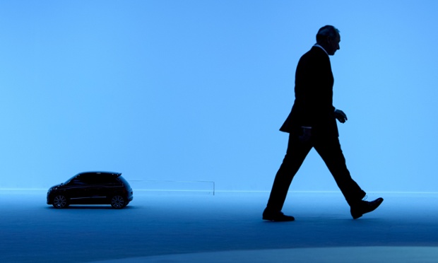 Renault's Chief Competitive Officer Thierry Bollore walks past a scale model of the new Twingo.