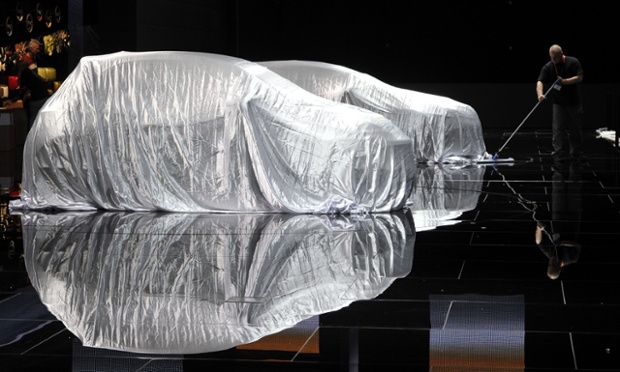 A pair of Opel cars are kept under wraps before the opening of the motor show.