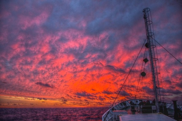 Red East Morning: 'A brilliant dawn breaks on the horizon far out in the open Atlantic as the ship slowly trundles east'.