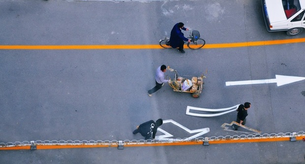 One way: 'Local maintenance men repainting road markings in our apartment complex Beijing'.