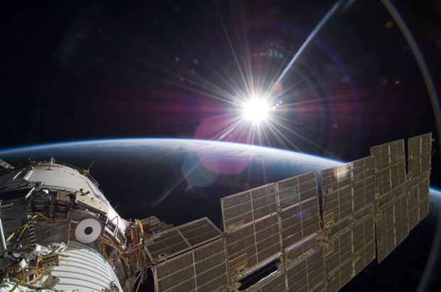 The sun greets the International Space Station from the Russian section of the orbital outpost, photographed by one of the STS-129 crew members