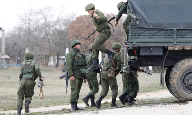Russian servicemen disembark from a vehicle at the Belbek airport in the Crimea region.