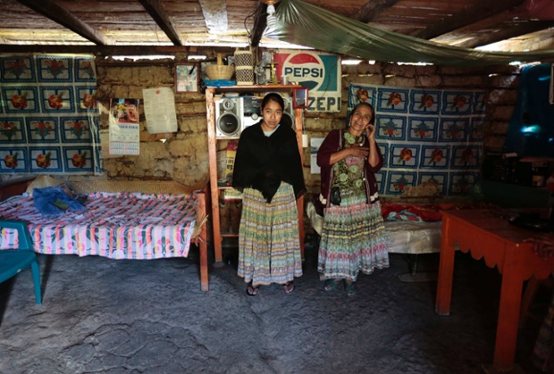 Alicia Chiquin, 43, and her daughter Fidelina Ja, 18, stand together at their home in Pambach, Guatemala. Alicia has no education and has always worked the land. Her daughter Fidelina also has no education and when she grows up she says she will continue to work at home and on the land.