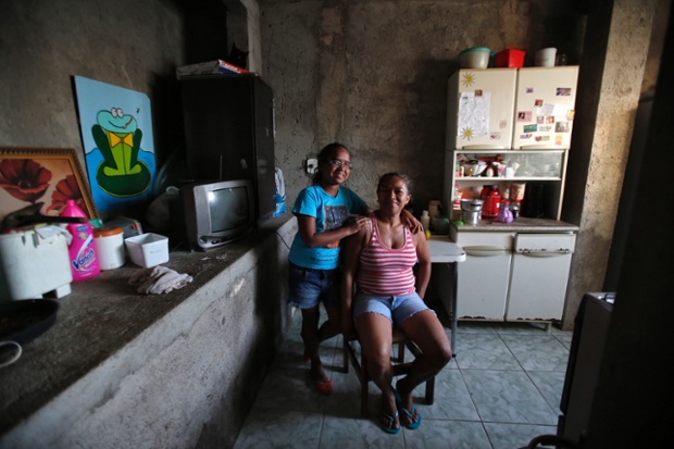 Raimunda Eliandra Alves, 45, poses for a photograph with her daughter Ana Paula Leonardo Justino, 10, at their home at the Pavao-Pavaozinho slum in Rio de Janeiro. Raimunda is a supermarket cashier who finished her education at age 19. When she was a child, she wanted to become a maths teacher when she grew up. She hopes that her daughter Ana Paula will become a veterinarian. Ana Paula says that she will go to high school and then finish college in 2025. She also wants to be a vet when she grows up.