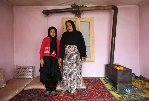 Noor Zia, 40, poses with her daughter Saba Ahmadi, 11, at their home in Kabul, Afghanistan. Noor, who is a teacher, studied until she was 28. Her ambition was to become a doctor, but she couldn't afford the fees. She hopes her daughter will become a well-known, highly skilled doctor. Saba wants to go to university, and would like to become a renowned lawyer.