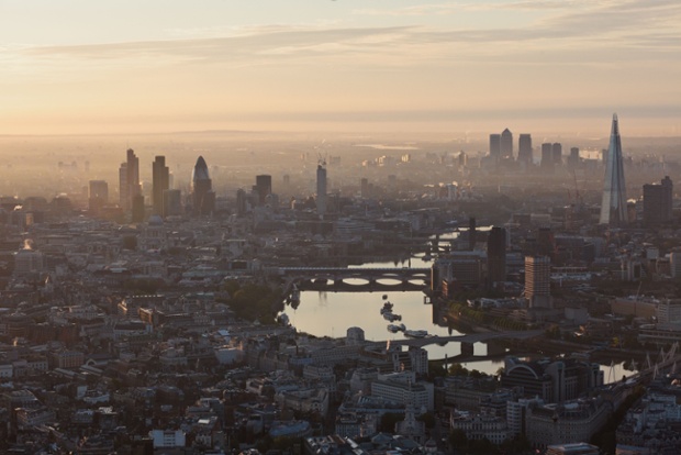 An aerial view of London at sunrise, in June 2012, looking east towards the City with Canary Wharf in the distance.