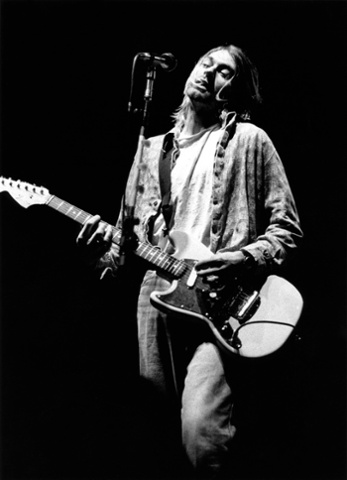 Kurt Cobain performing live onstage at Palasport, Modena, playing Fender Mustang guitar