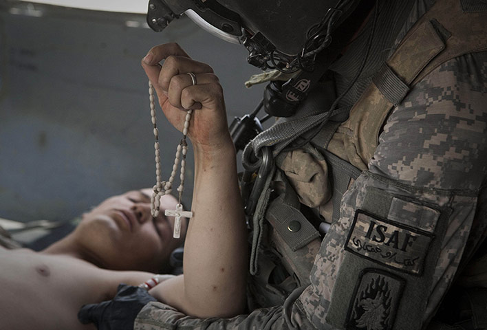 20 Photos: Lance Corporal Blas Trevino is treated on a helicopter in Afghanistan