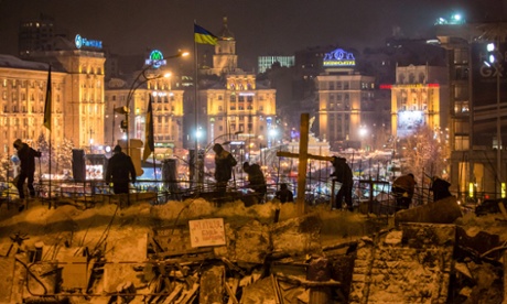 Anti-government protesters reinforce a barricade blocking access to Independence Square in December.