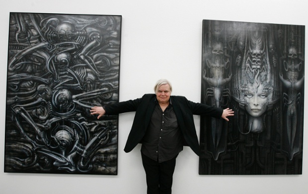 HR Giger  poses with two of his works at his exhibition at the art museum in Chur, Switzerland.