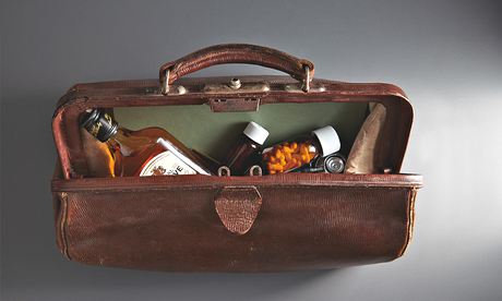 An open doctor's bag with whisky and drugs inside