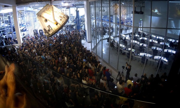 SpaceX workers watch the Falcon 9 SES 8 launch form the company's HQ in Hawthorne, California.