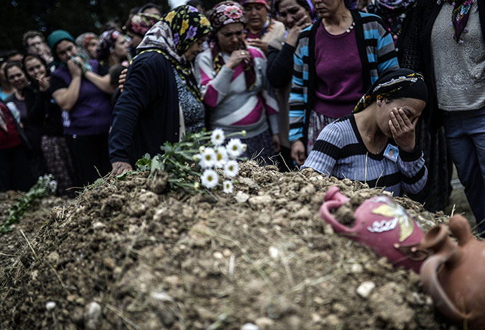 20 Photos: Duygu Colak reacts in front of her husband Ugur's grave in Soma, Turkey