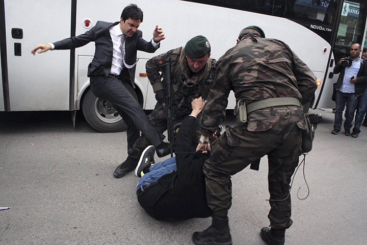 20 Photos: A protester kicked by Yusuf Yerkel, aide to Turkey's prime minister Erdogan