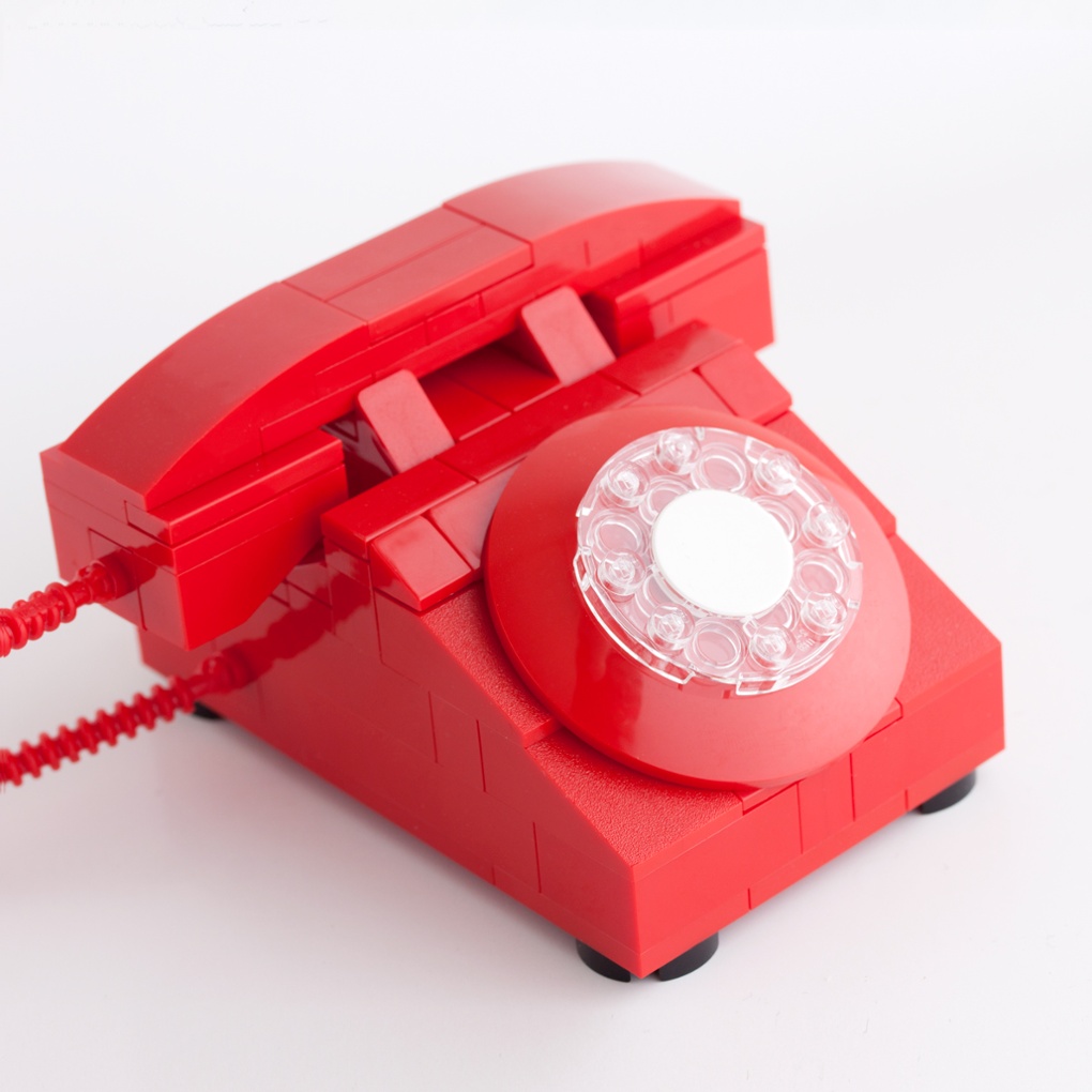 This rotary phone model in bright red is a tribute to a classic piece of tech. Only use in the event of an emergency!