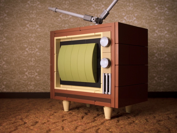 My First TV. A '60s-era television set in warm tones that evoke wood grain and fabric textures.