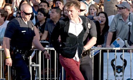 Vitalii Sediuk is led away at the Maleficent premiere