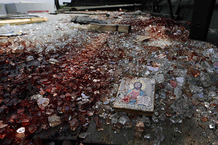 20 photos: A bloodstained icon of Jesus atop a wrecked truck near the Donetsk airport