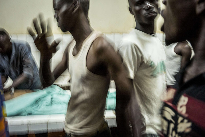 20 photos: Relatives react as two bodies are prepared at a morgue in Bangui
