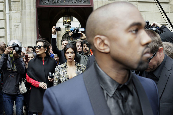 20 photos: Kim Kardashian walks behind her partner Kanye West in Paris